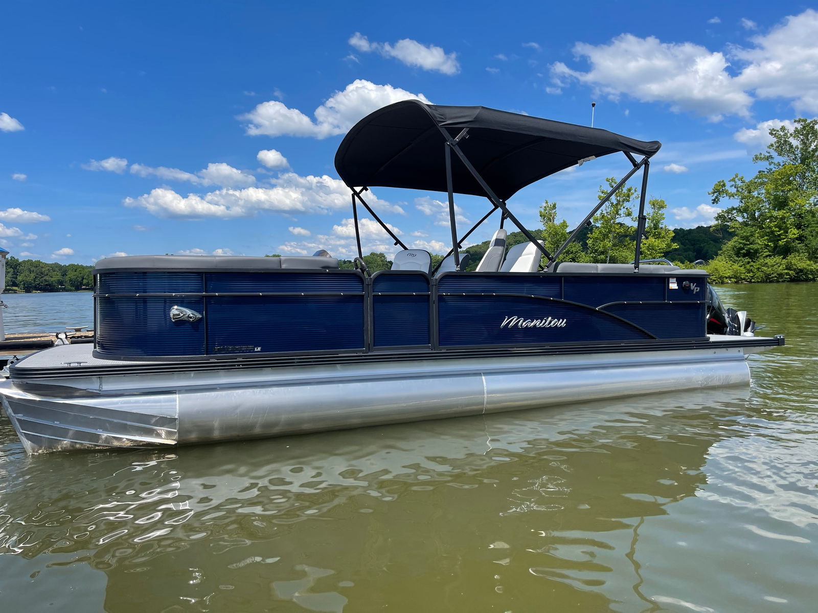 Tin Cup blue Manitou Aurora docked at Tennessee National Marina