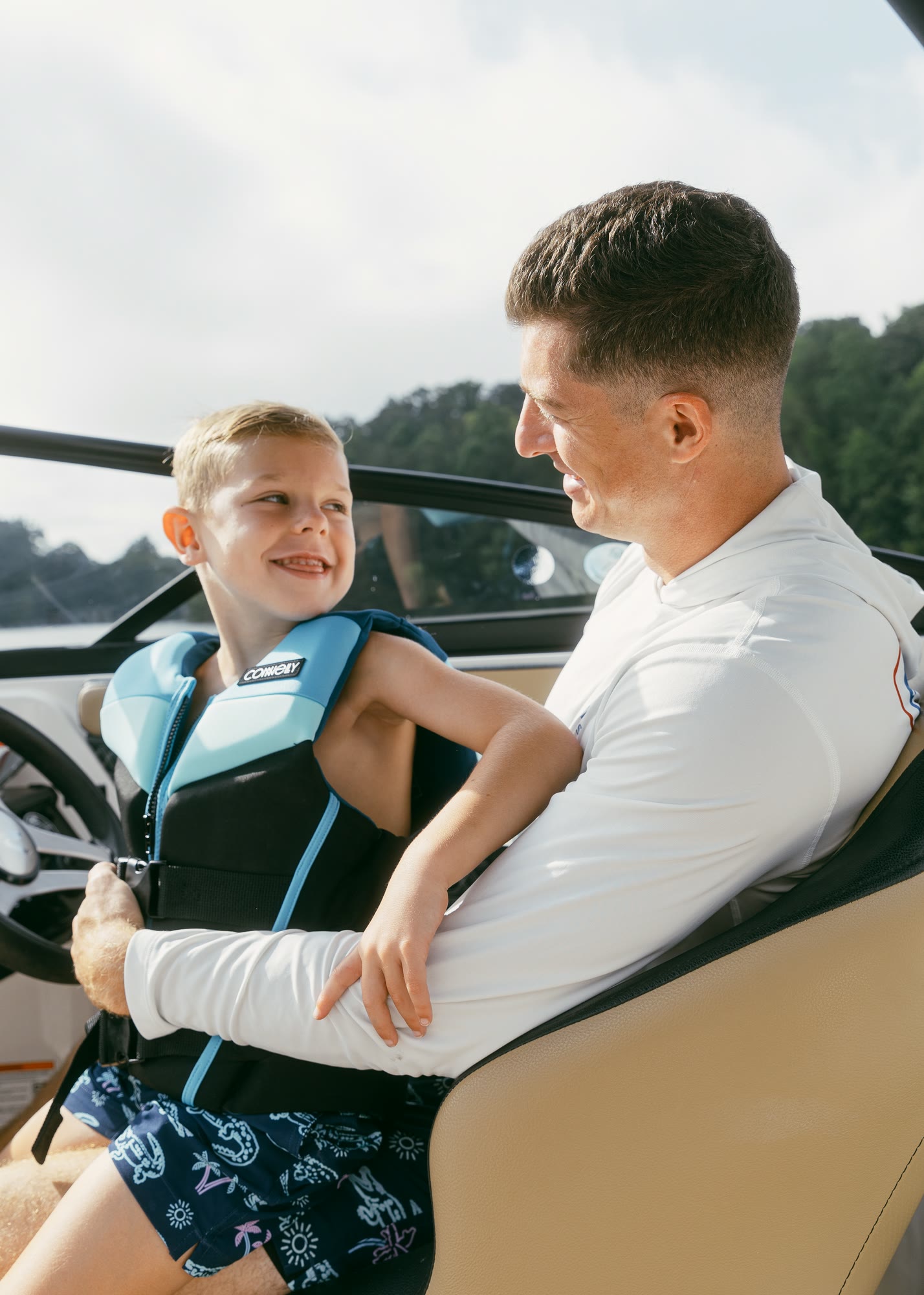 A father and son at the helm of a boat