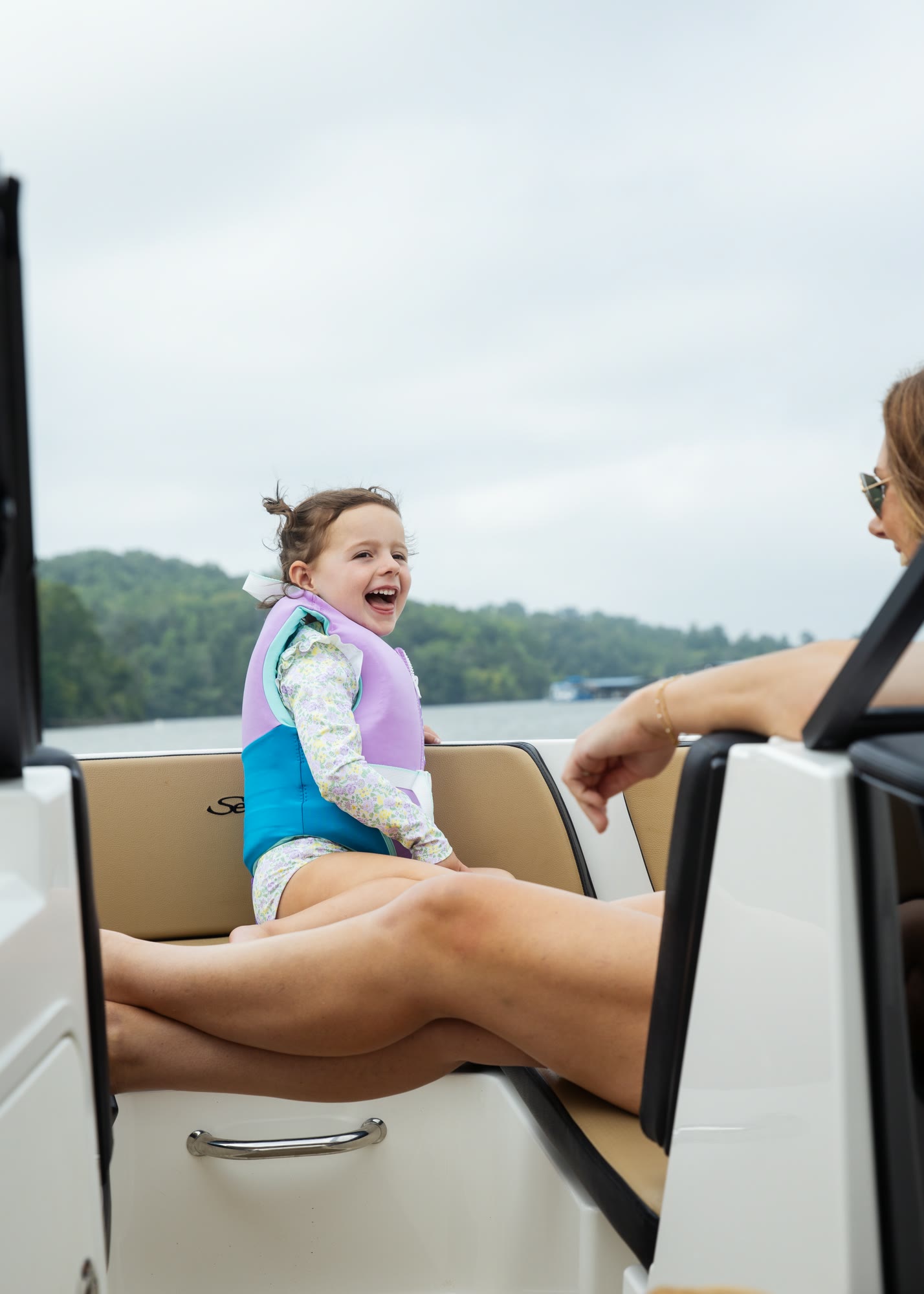 A guest laughing aboard a club boat