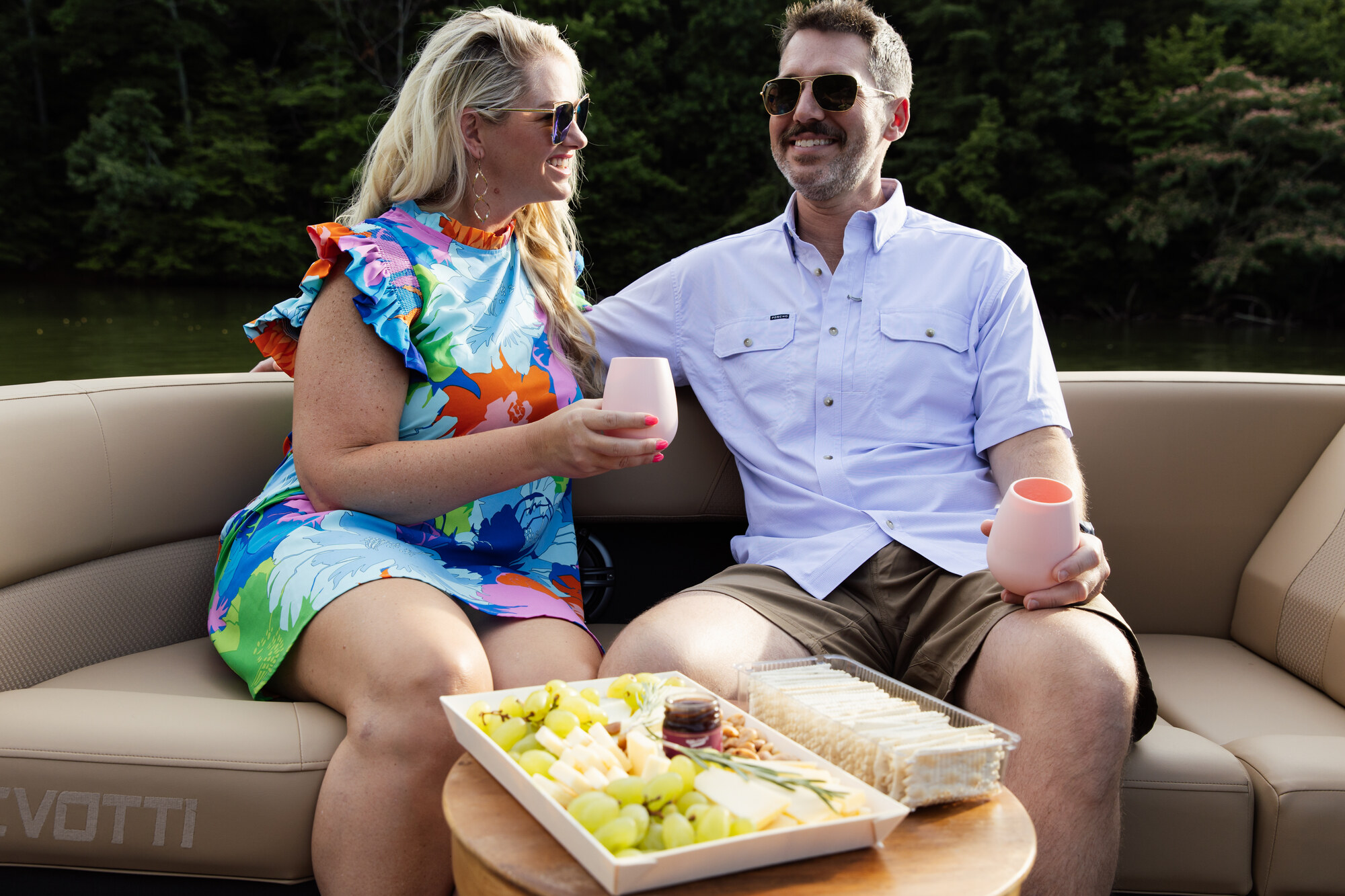 A couple relaxing together with drinks aboard a boat on an easy afternoon