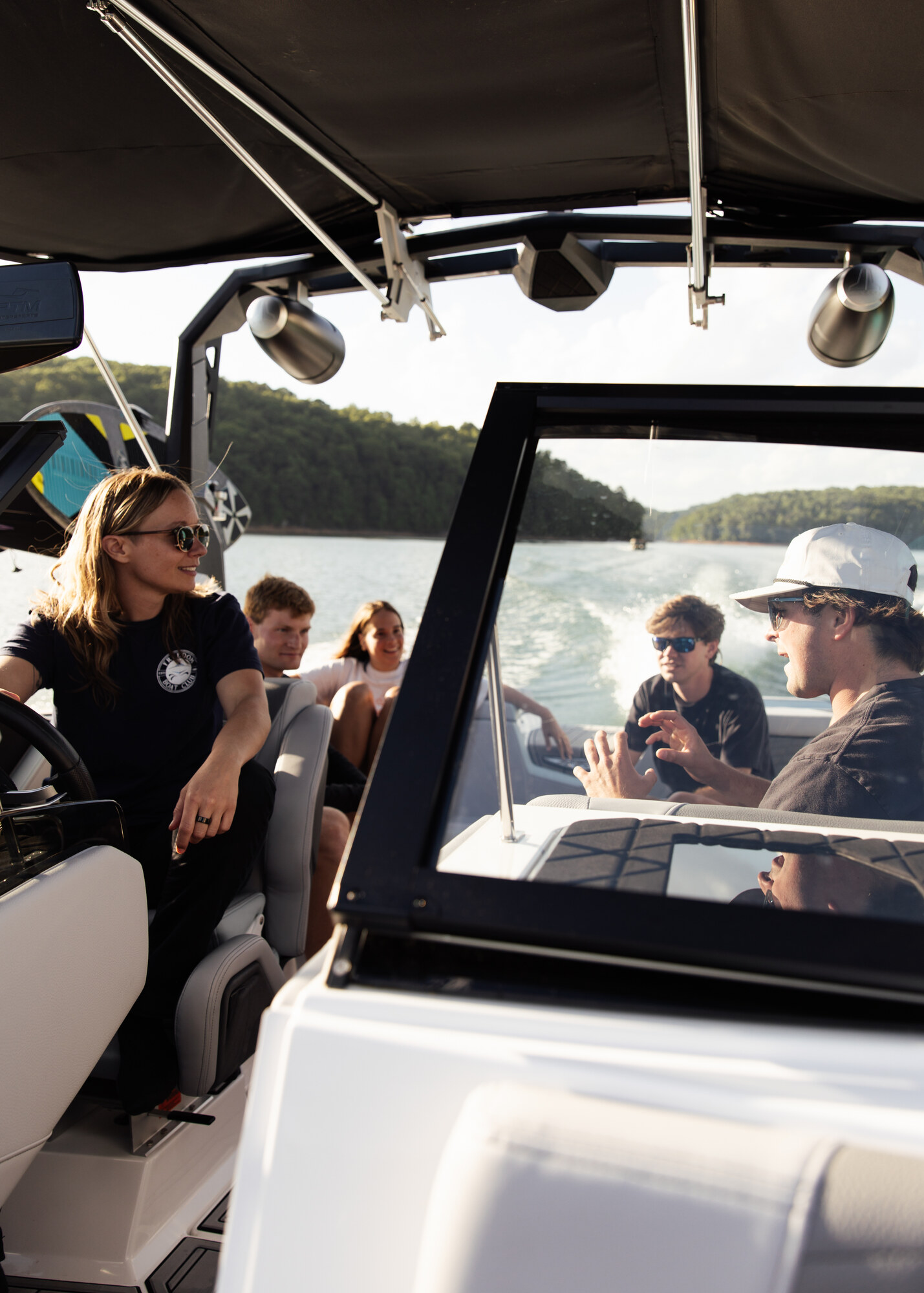 A Freedom Boat Club team member helping guests become comfortable at the helm