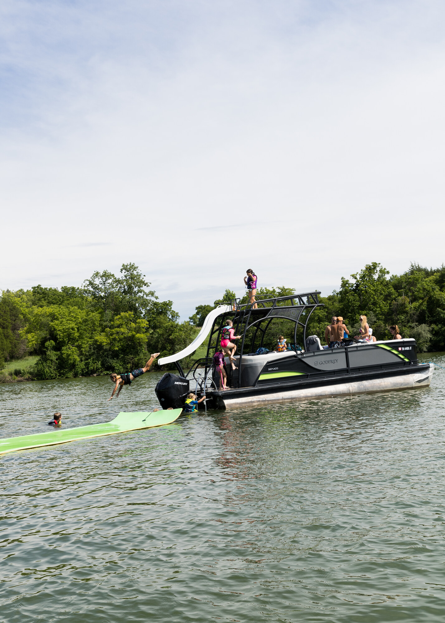 A double-decker club boat with a slide carrying families on Fort Loudoun Lake