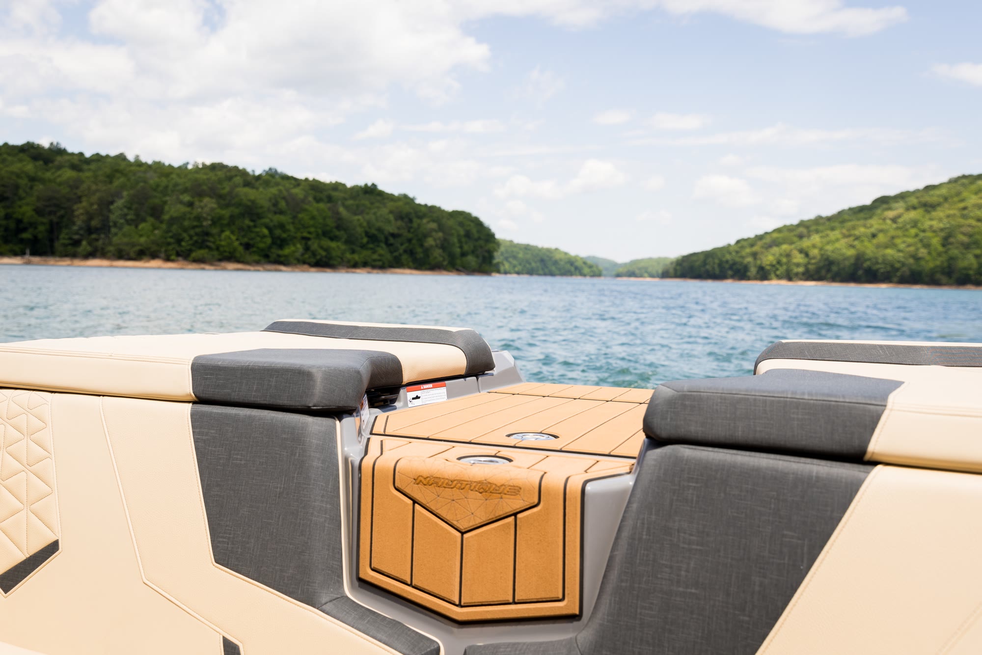 The stern seating and deck detail of a Nautique resting at the dock