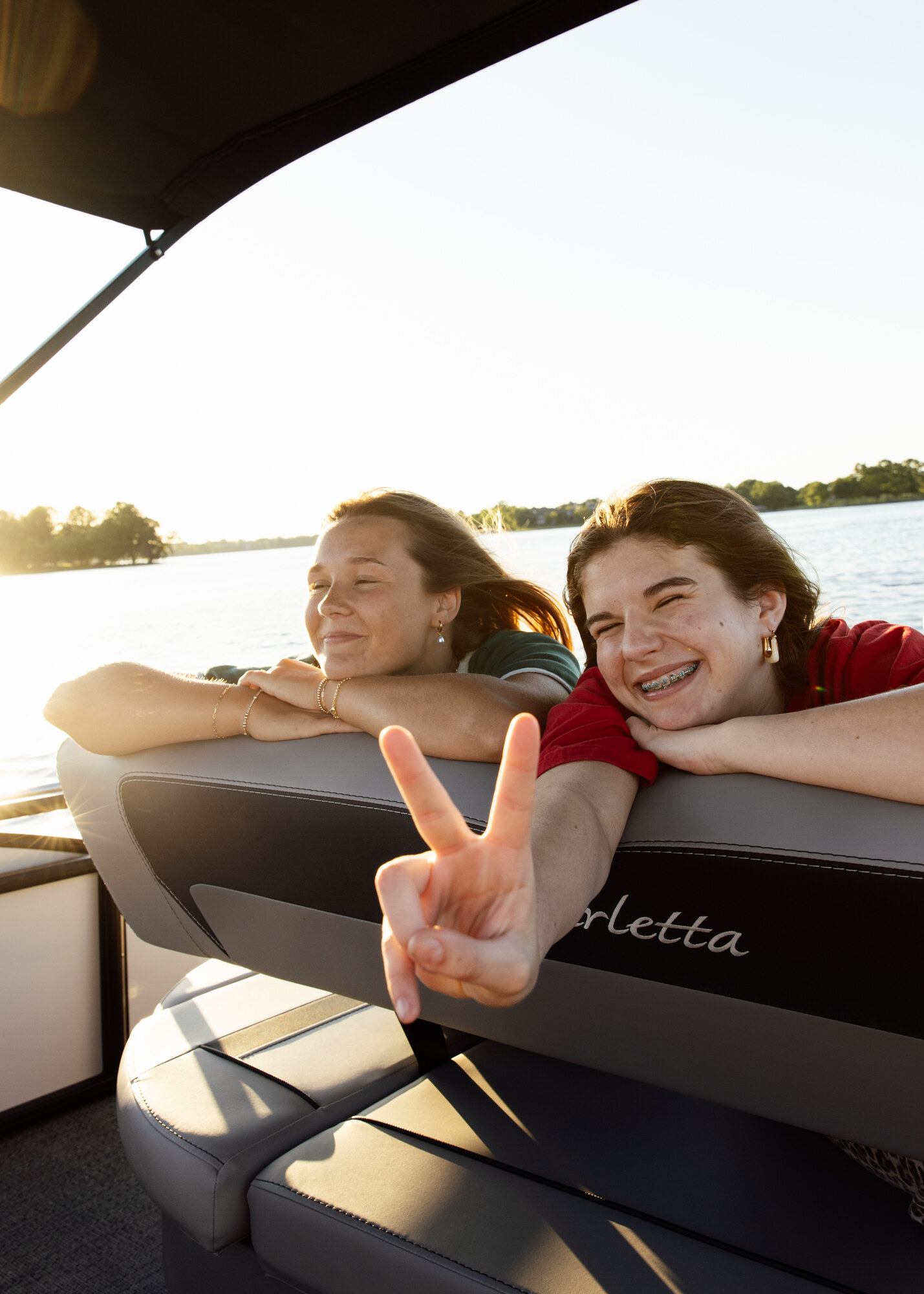 Two friends enjoying a golden-hour boat ride