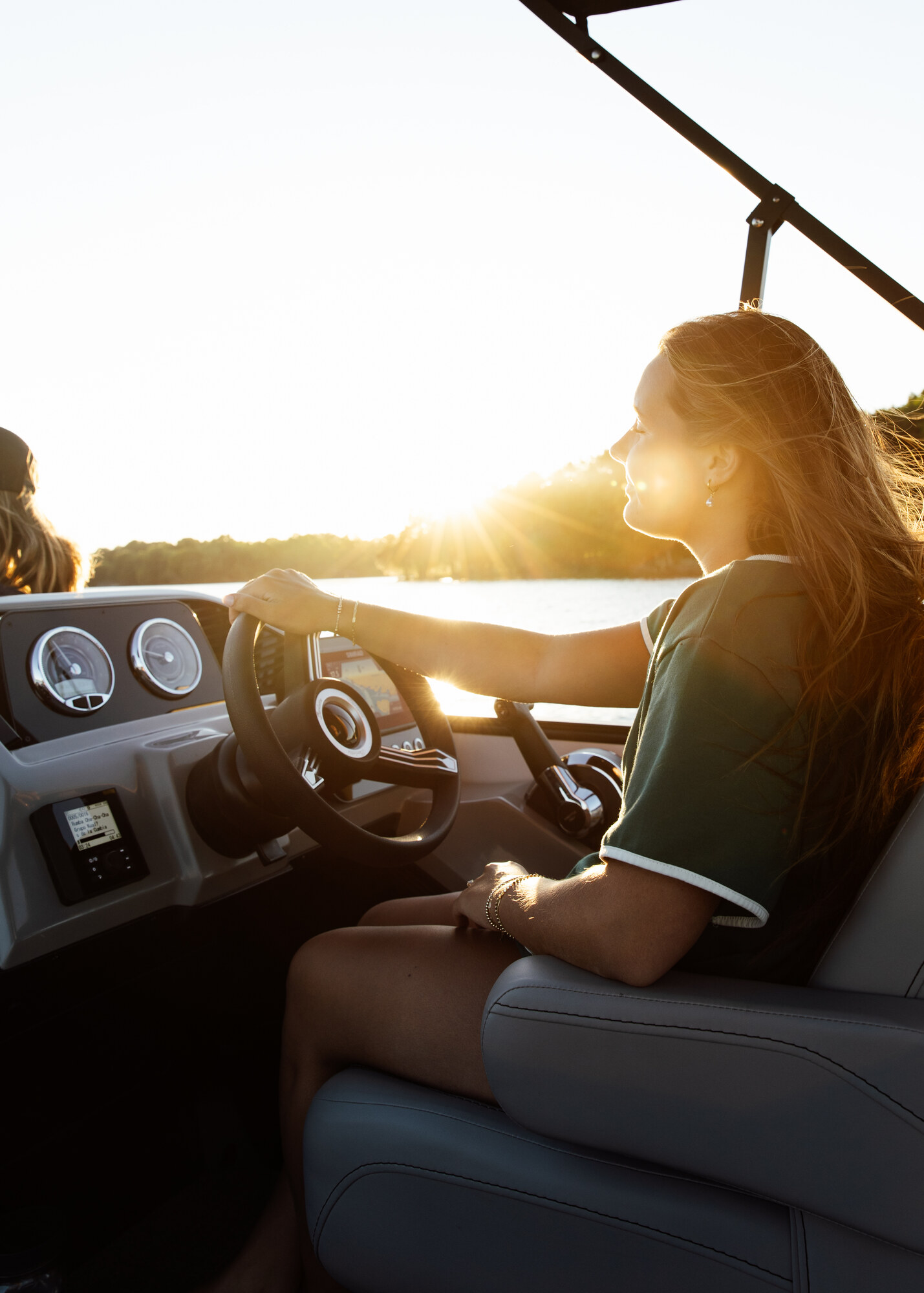A member at the helm during a golden-hour cruise on Percy Priest Lake near Nashville