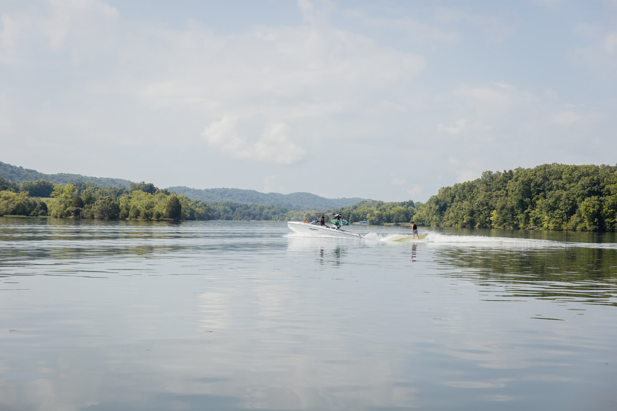 A quiet expanse of Tennessee lake water framed by wooded hills