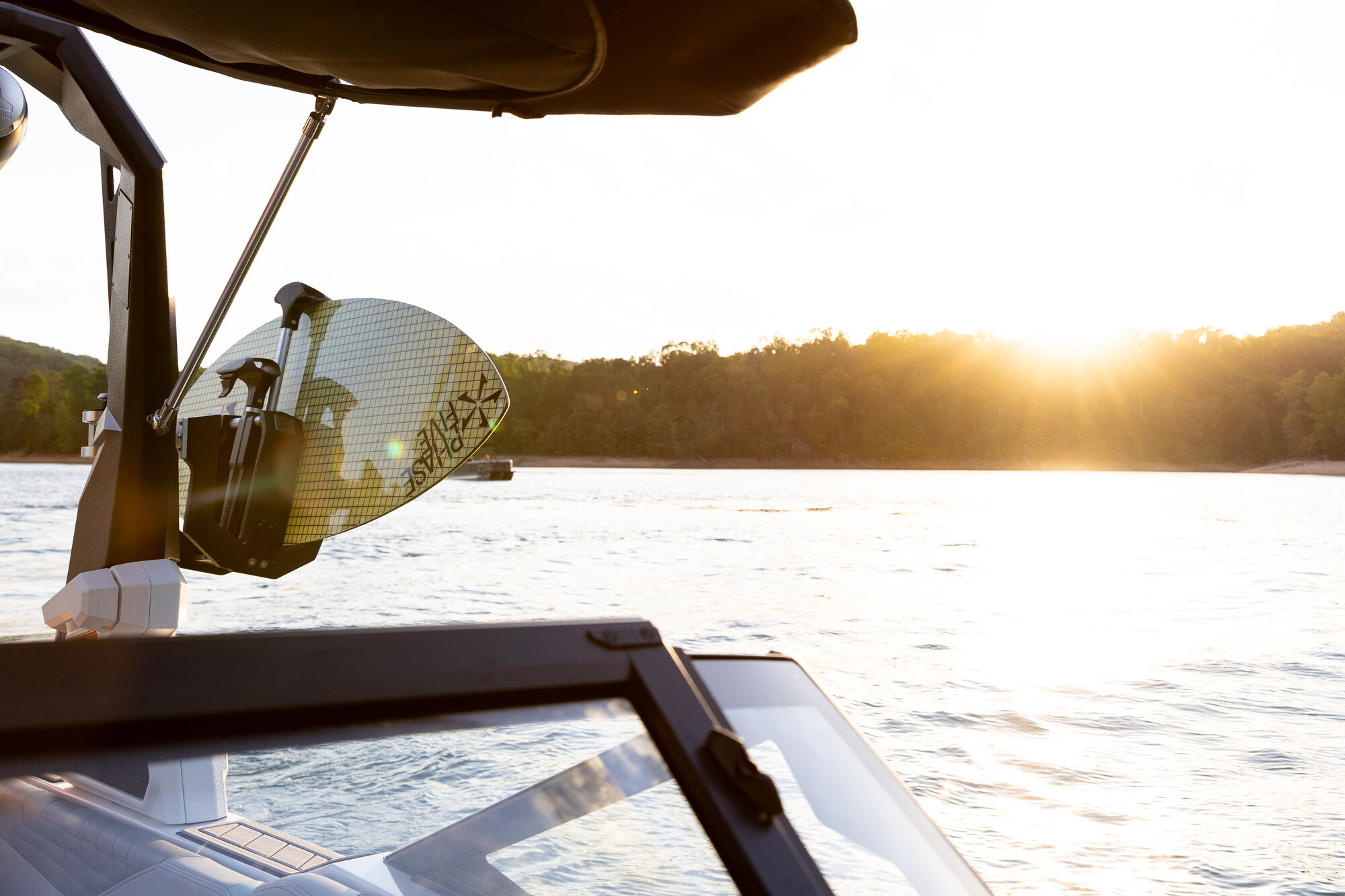 Still Tennessee water and a watersports board at sunset