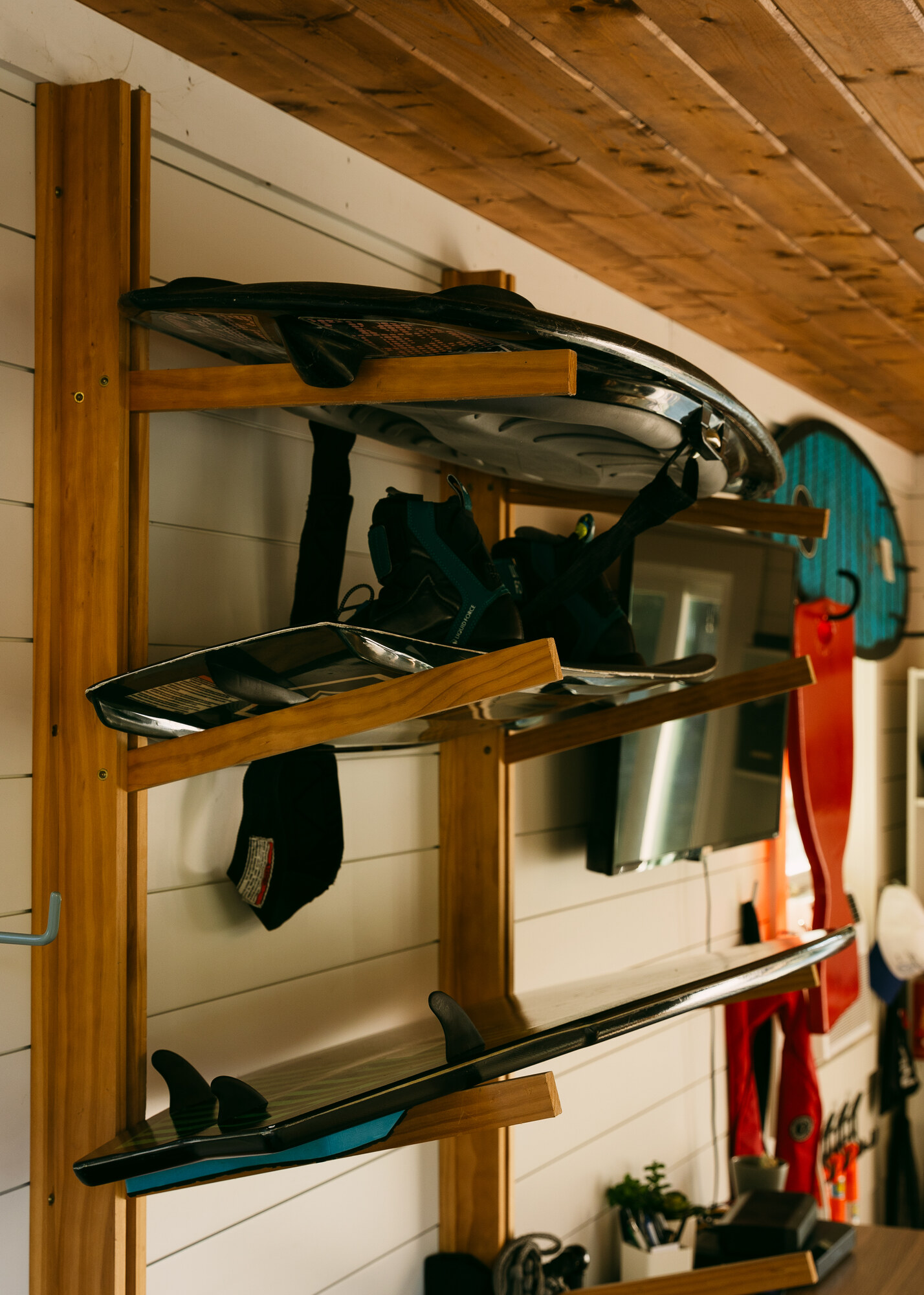 Boards and skis stored in wooden racks inside the club office
