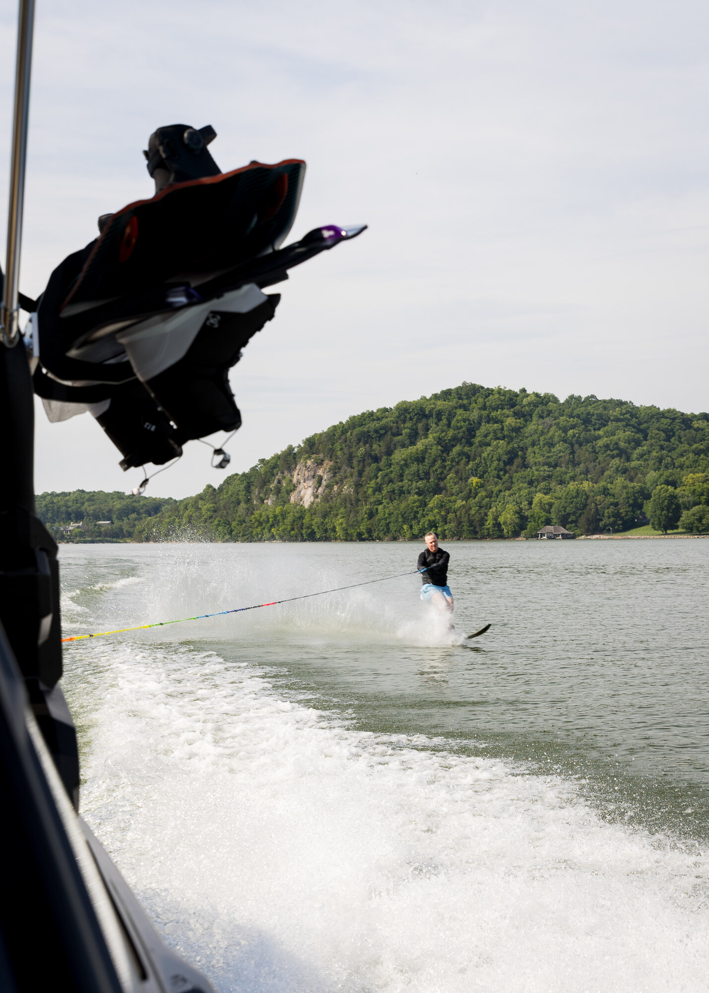 A waterskier carving a turn behind a club boat